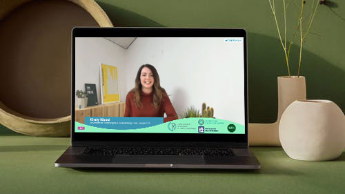 Laptop showing presenter with graphic overlay during a live stream event.