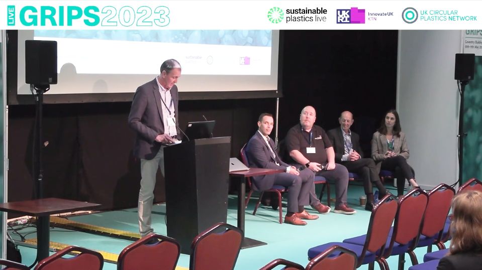 Panellists shown onstage at the GRIPS 2023 Conference during live stream