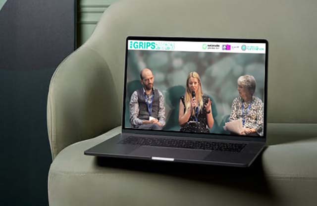 Close up camera angle of three panelists onstage at GRIPS 2023 Conference live stream, shown on laptop