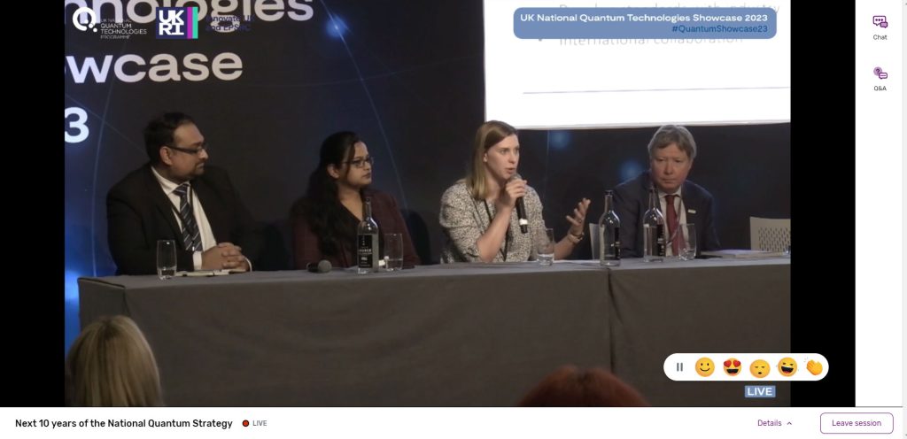 4 presenters on stage in front of projector during a live streamed presentation.