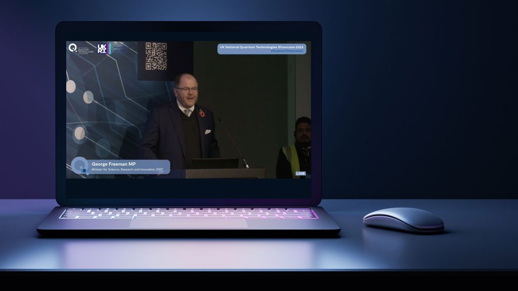 George Freeman MP on stage presenting at a streamed live event.