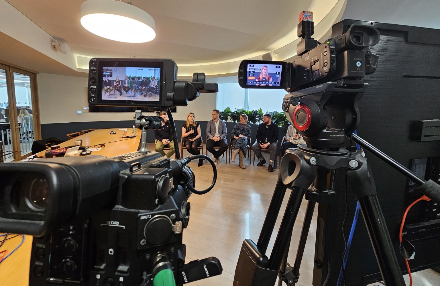 View of panel through the camera lens during live stream